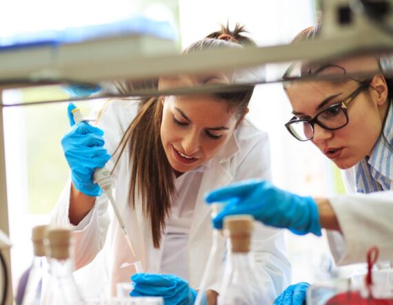 Two women in a science lab working on research experiments