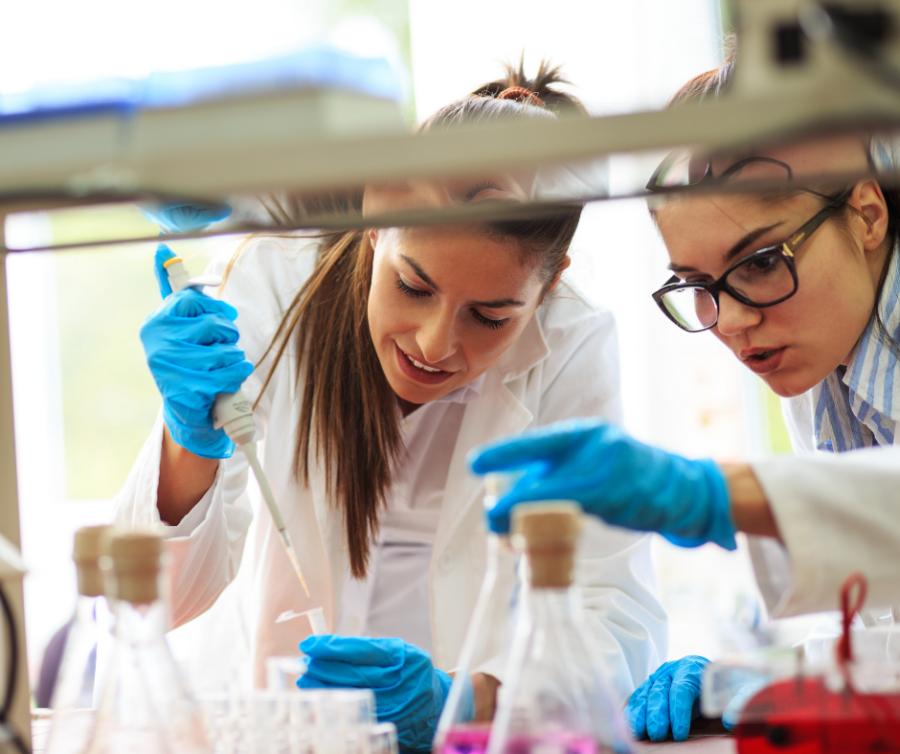 Two women in a science lab working on research experiments