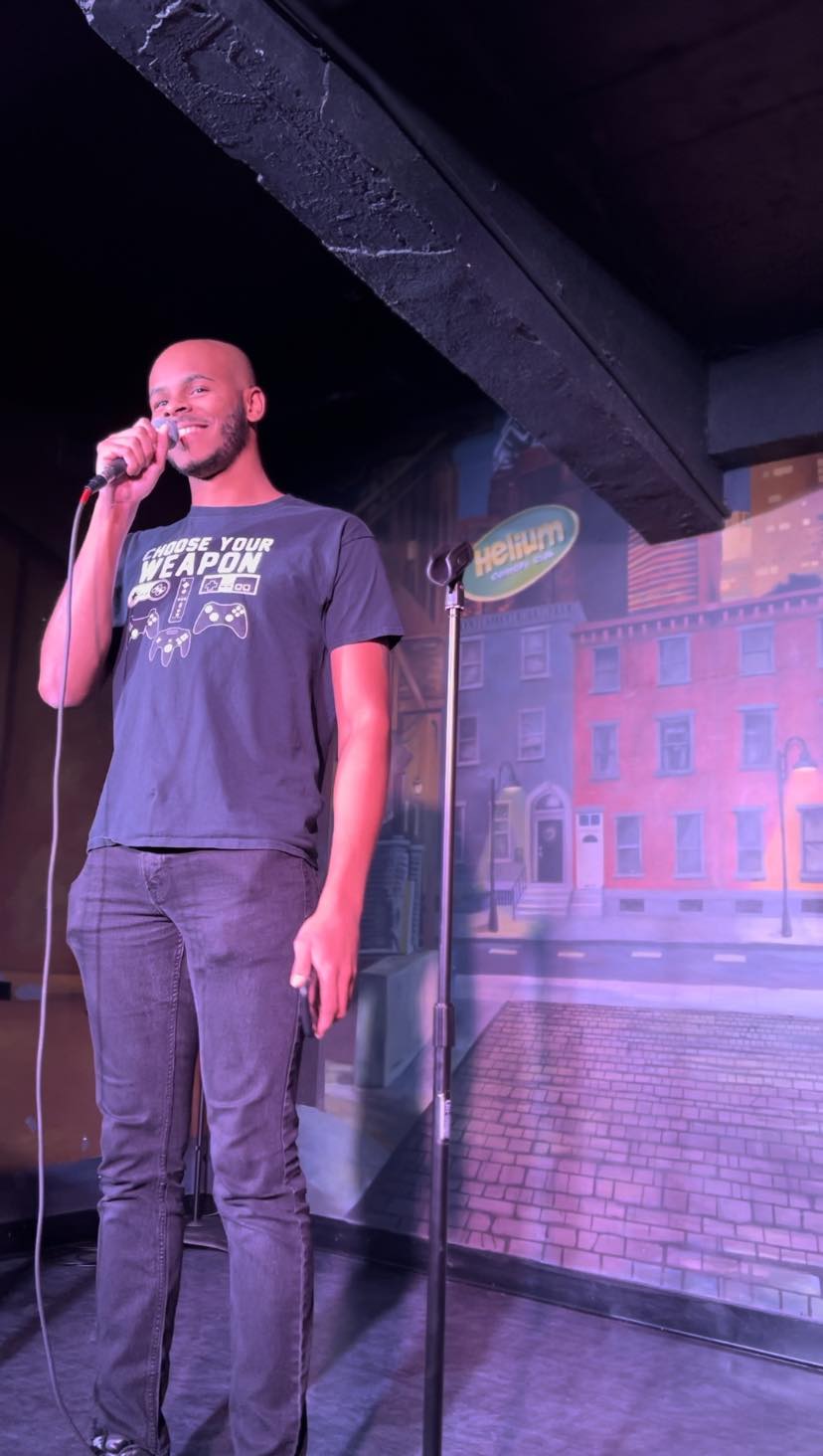 Mylin performing a pun routine at Helium Comedy Club.