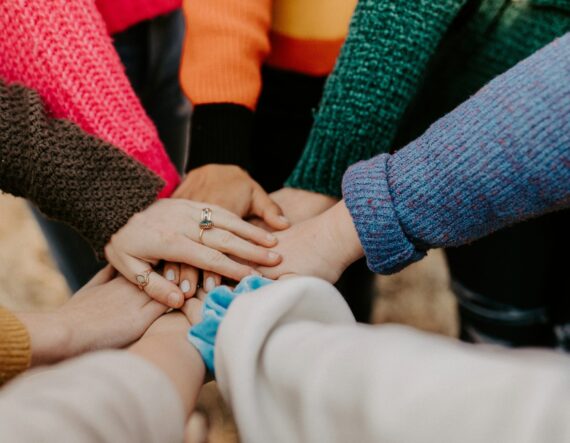 a group of people's hands in a circle